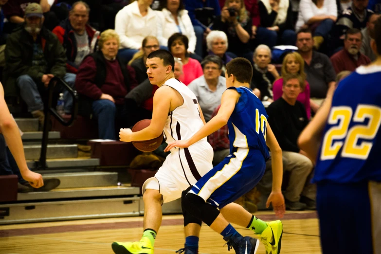 two basketball players on opposing teams during a game