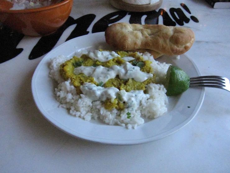 a white plate topped with rice and a pastry