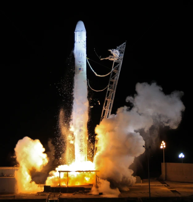 a space shuttle lifts off on a nighttime mission