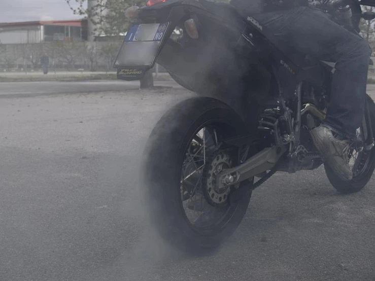 a man on a motorcycle driving in the street