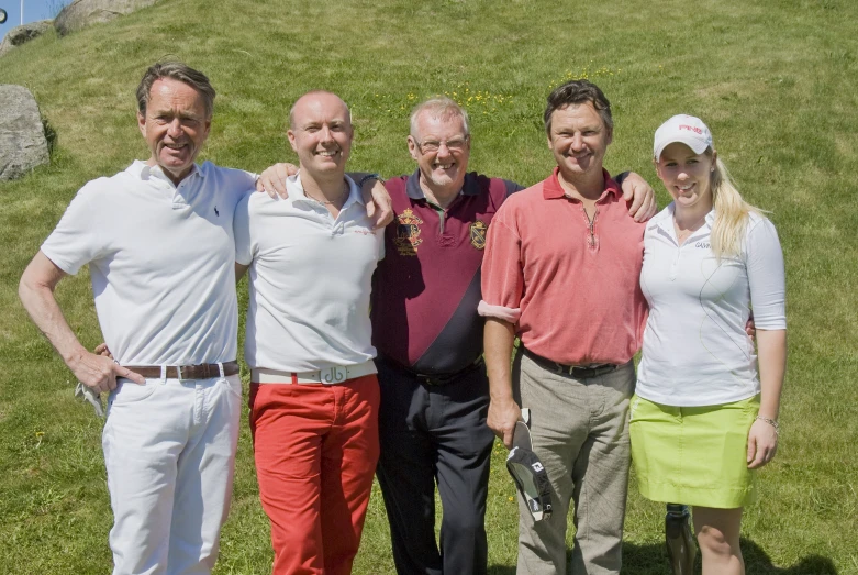 four men and a woman posing for a picture together