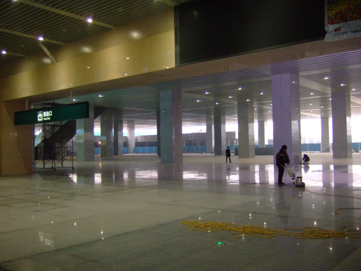 a group of people walking through a lobby