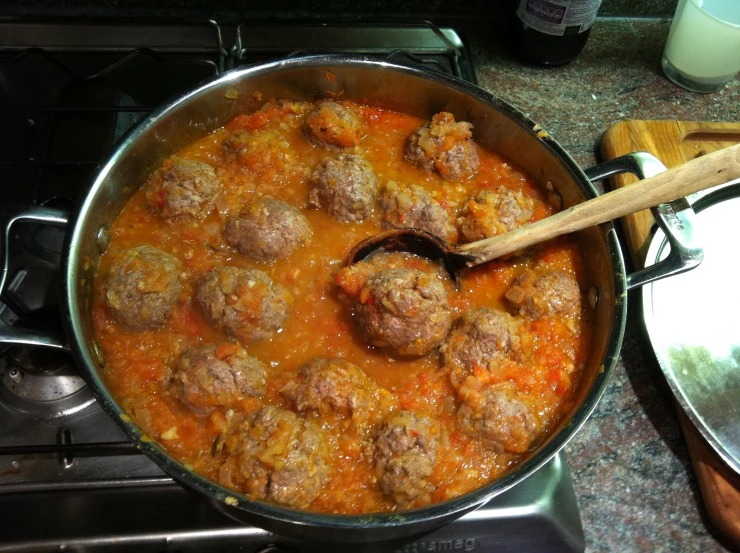 meatballs and carrots cooking in a sauce pot