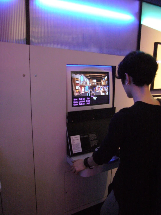 a man looks at a television while playing a game