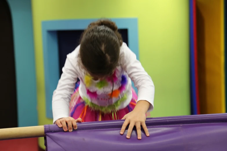 a small child in front of a purple object