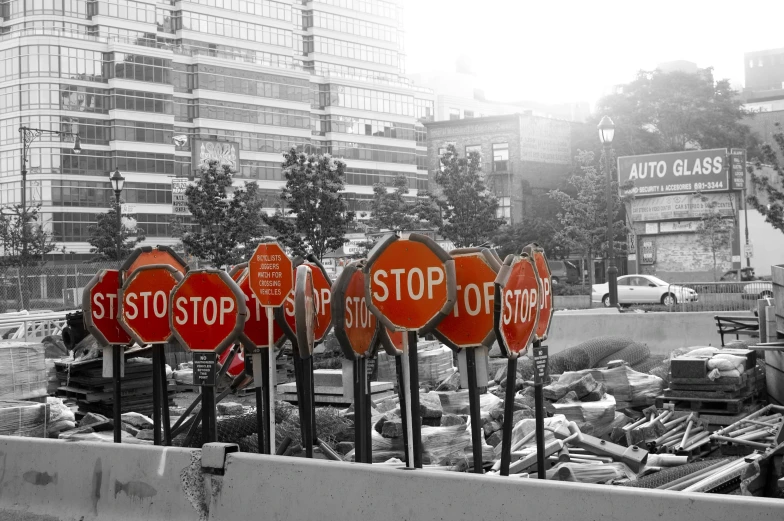 some stop signs sitting on top of metal poles