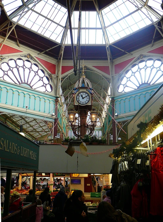 the inside of a building with people shopping and walking