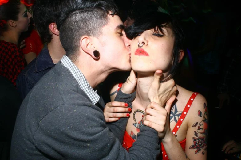 a couple kissing each other in a club