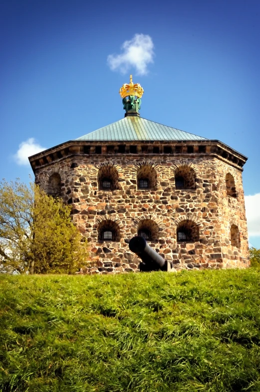 the building has a stone roof with a green roof