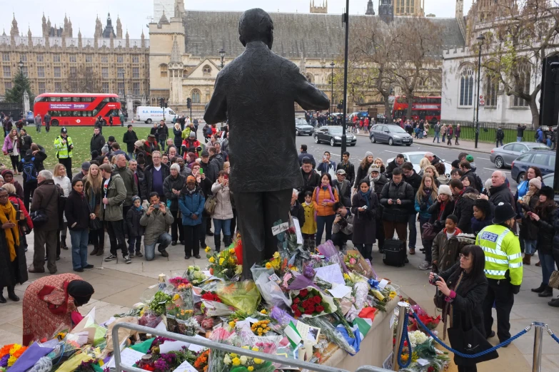 a statue of a man surrounded by people