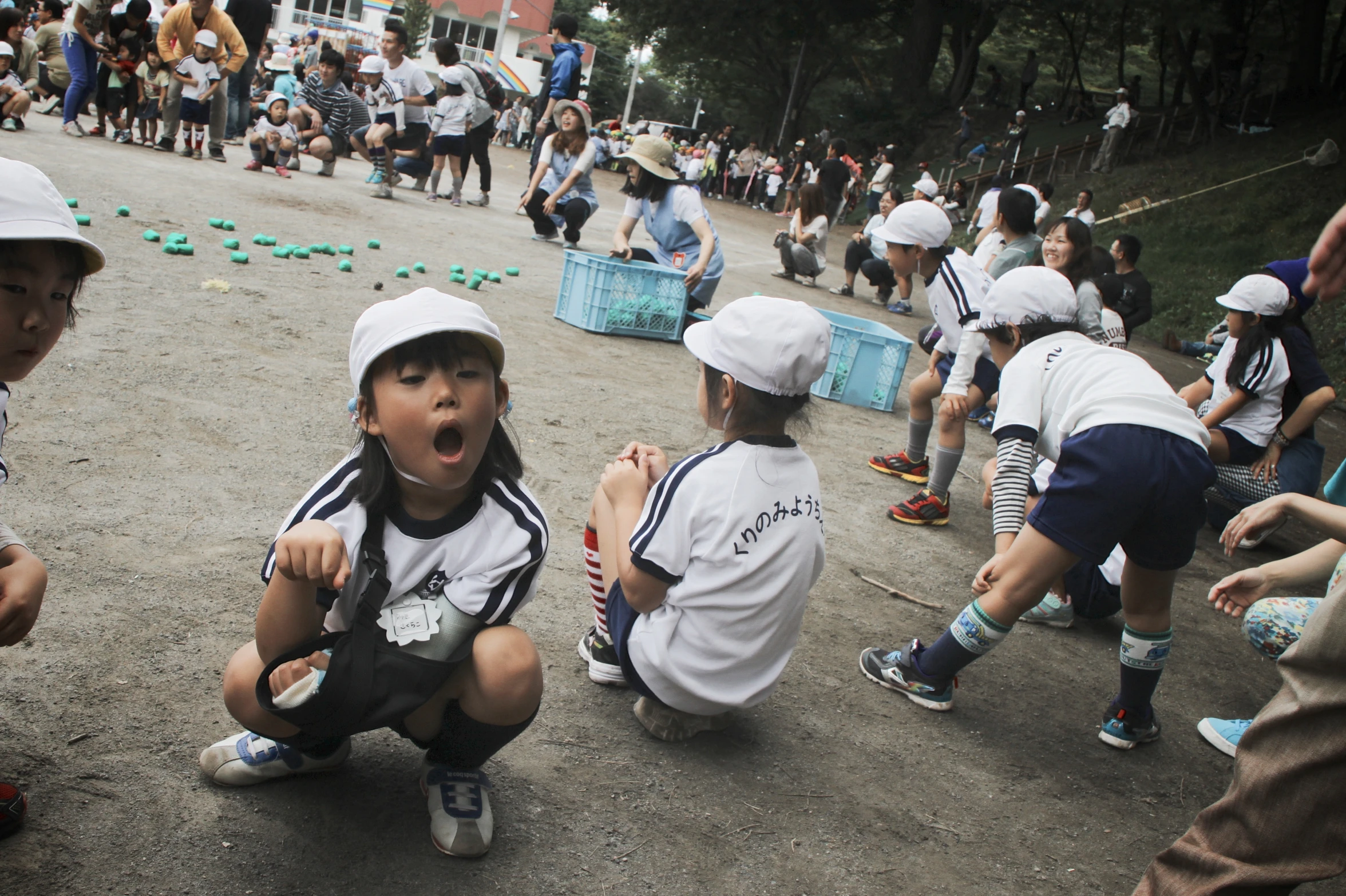 there are many children playing baseball on the concrete