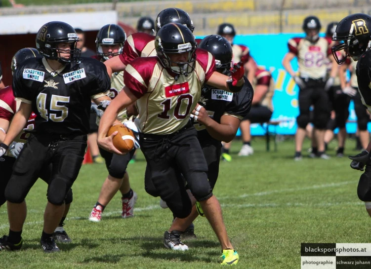 two teams playing a game of football, with one running for the football