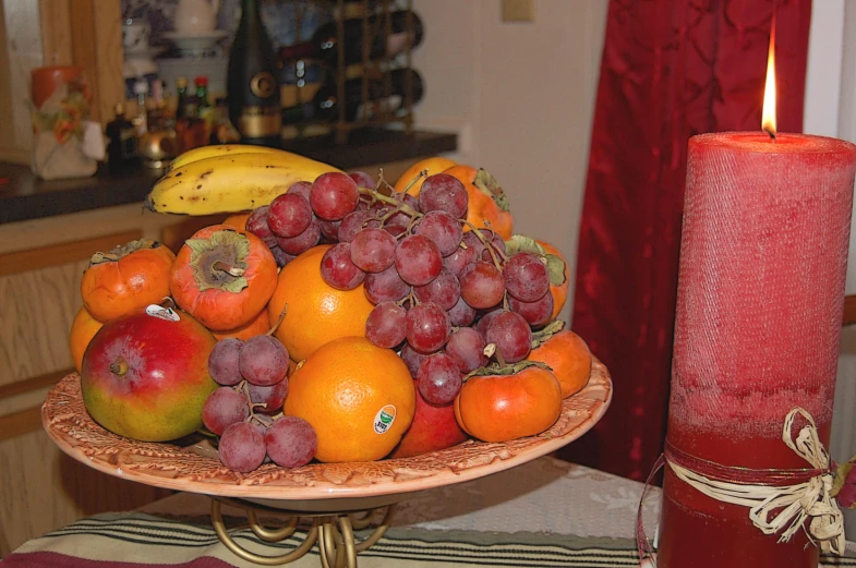 the fruit plate has gs, peaches, oranges and an apple on it