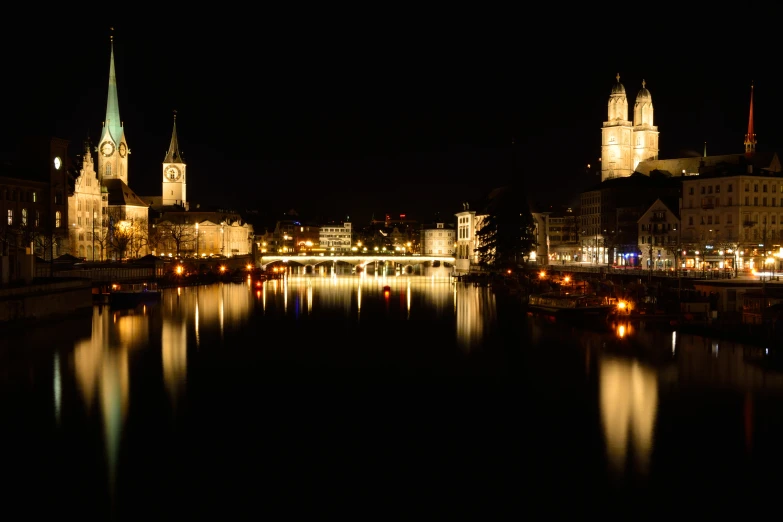 a river is illuminated by various buildings and lights