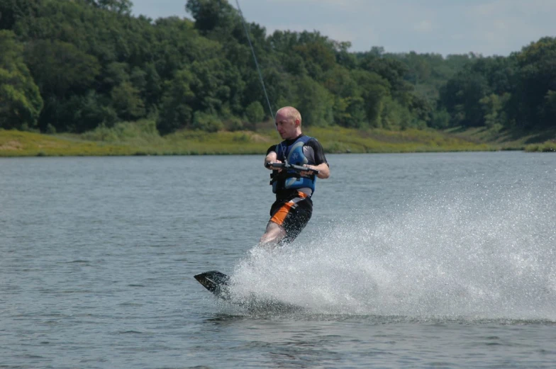 the man is skiing while he is water - boarding