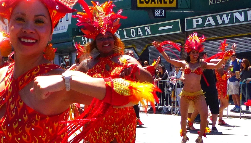 a group of people standing around each other at a parade