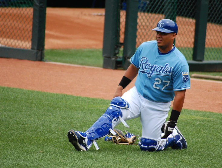 there is a baseball player leaning against the ground