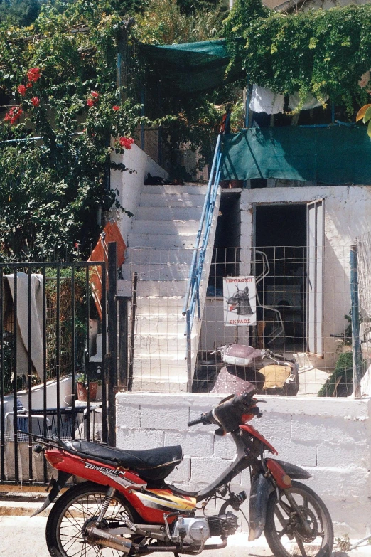 a motor bike that is parked in front of a house