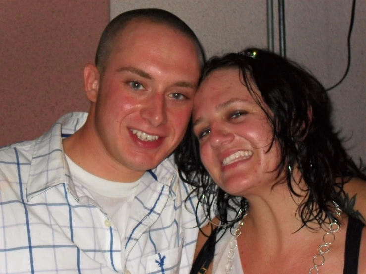 a smiling man and woman pose for the camera