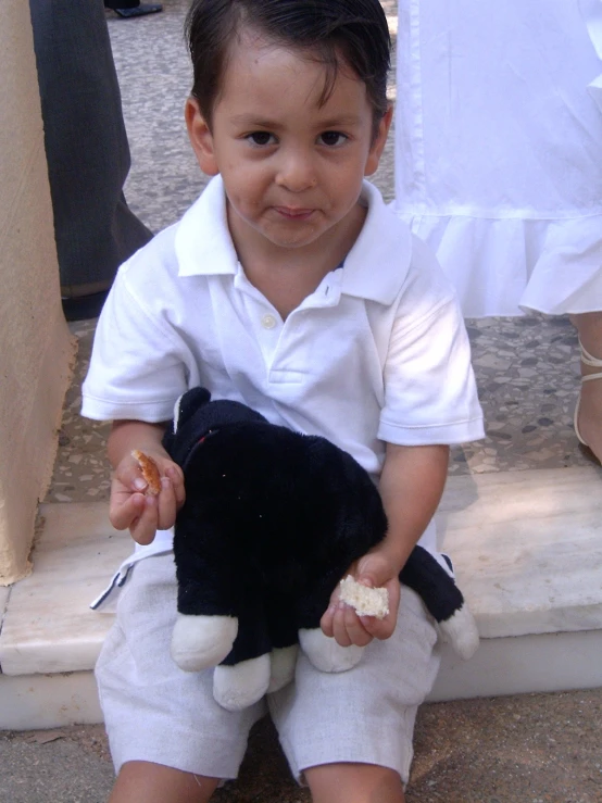 the small child holds onto a stuffed toy