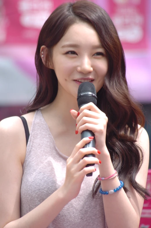 a asian girl with long hair and a microphone