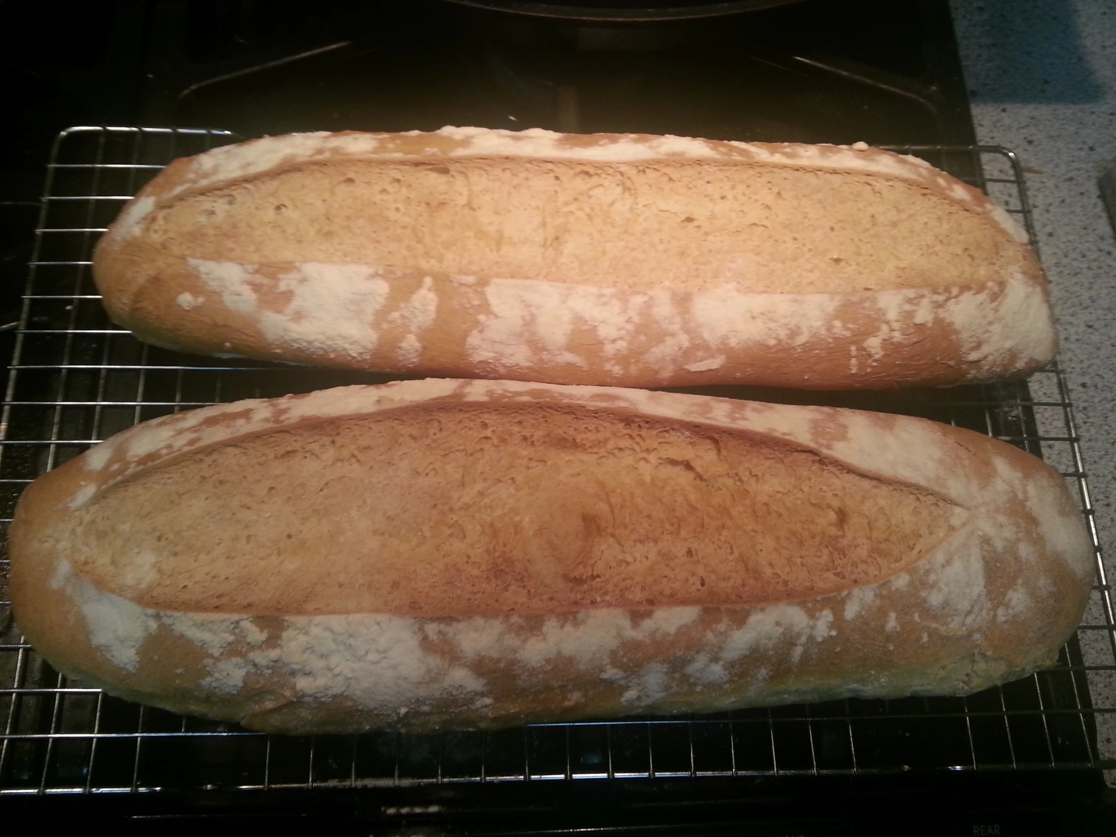 two slices of bread sitting on a metal rack