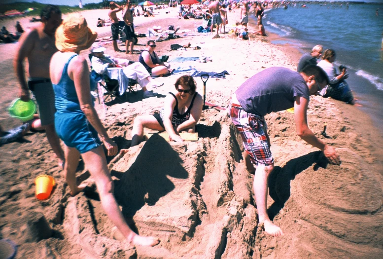 people on the beach enjoying an art project