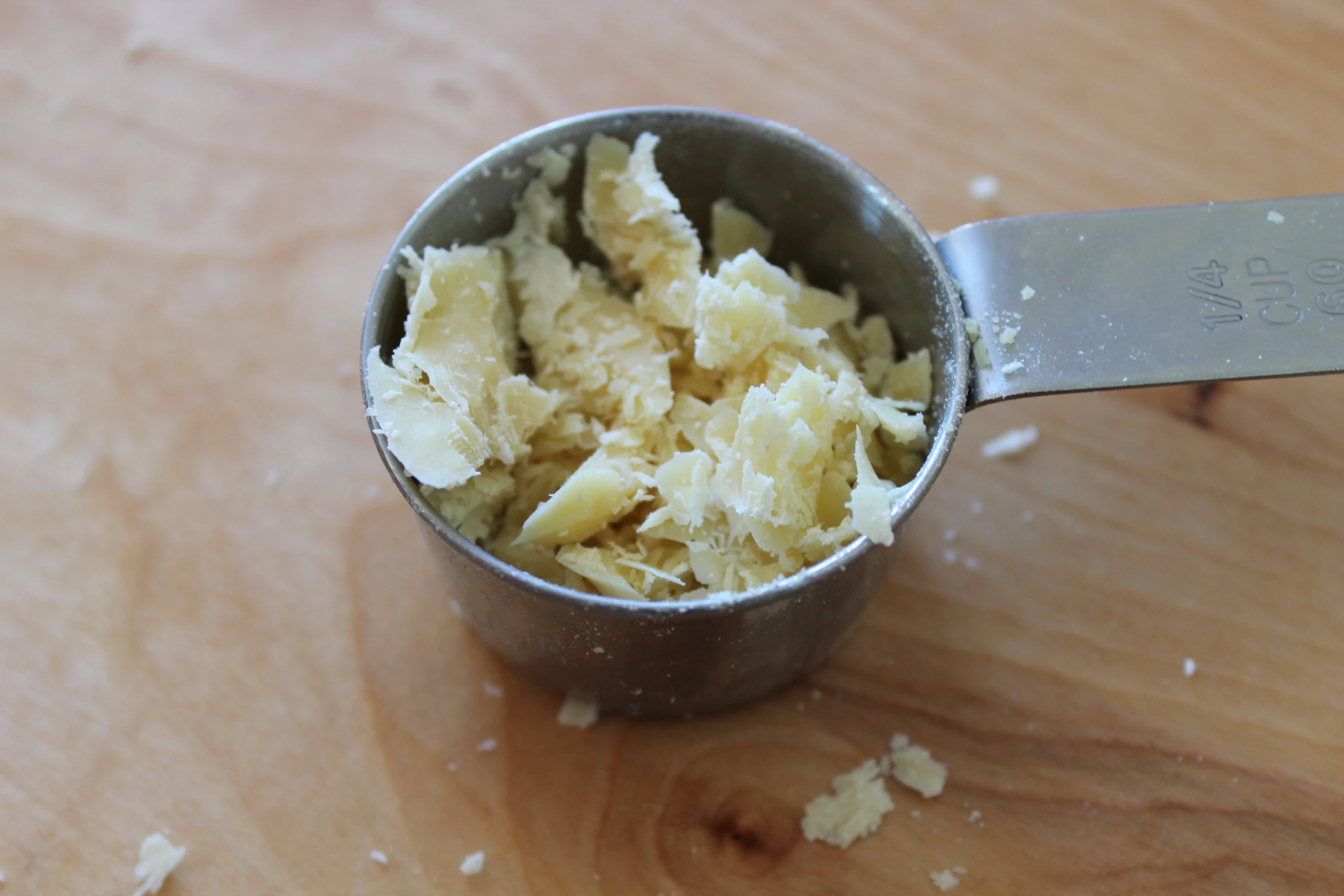 the food in a silver measuring cup is broken