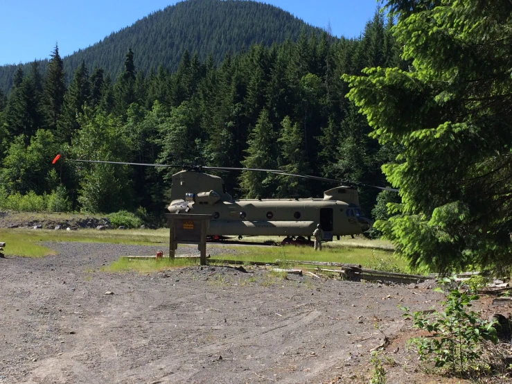 a army helicopter parked by the side of the road