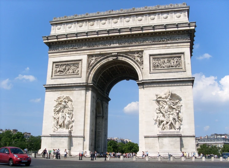 a car parked in front of a stone archway