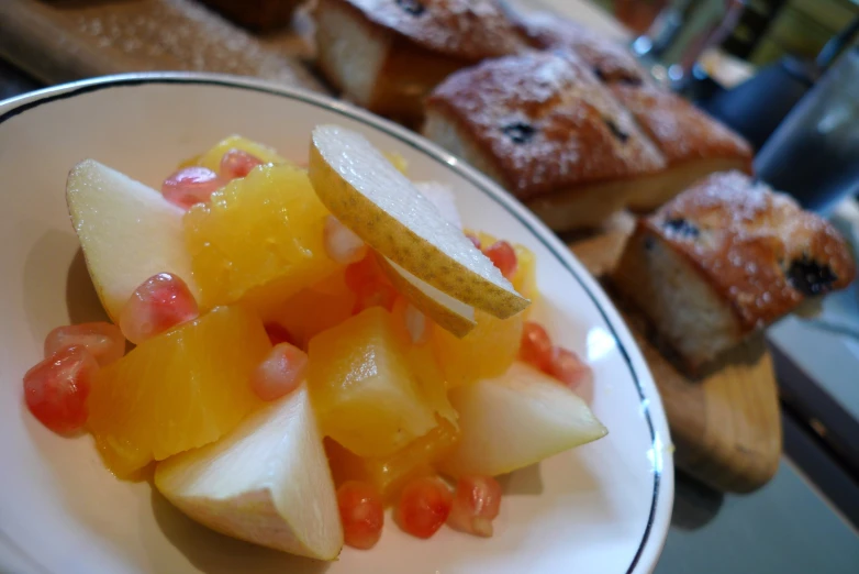 an arrangement of cut up fruit and some bread