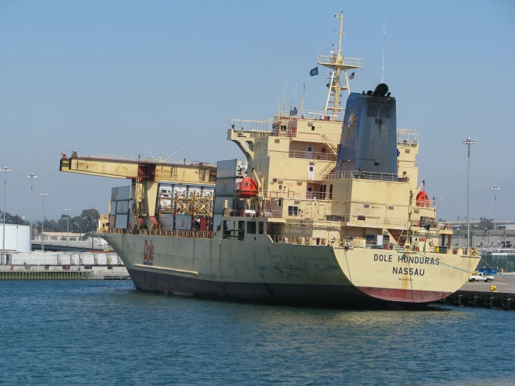 large ship docked in body of water near pier