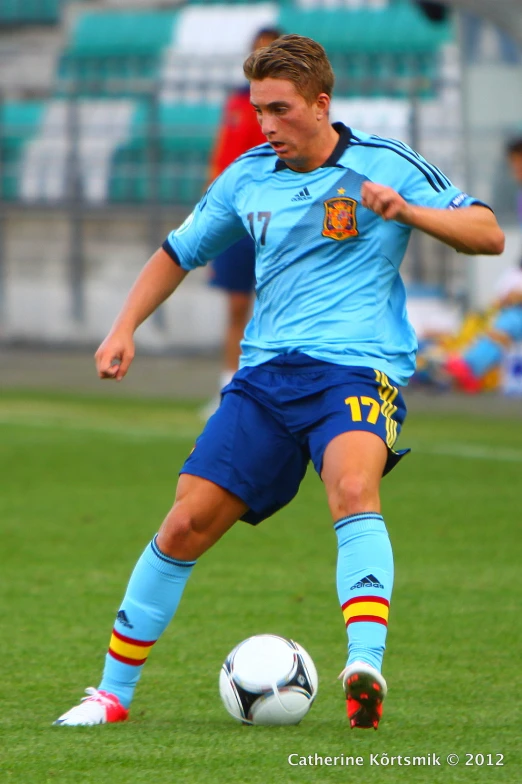 a young man playing soccer on the field