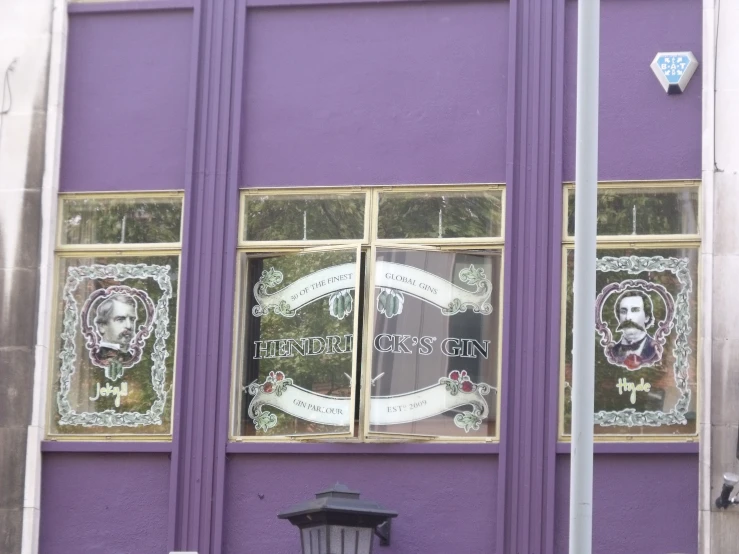 a purple building with two large windows on one side