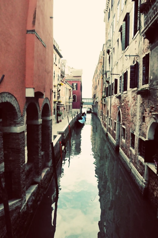 a narrow canal with several buildings on each side