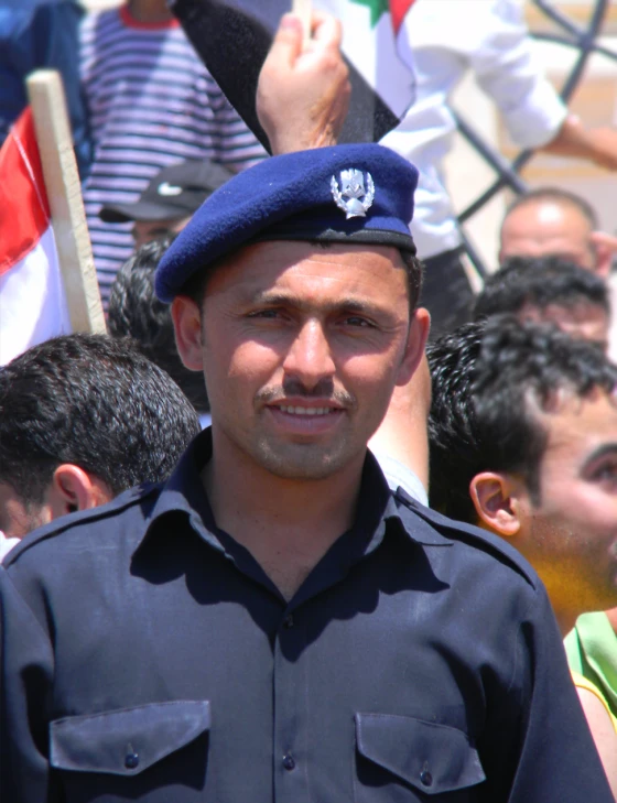 a man is wearing a blue uniform with a leaf on it