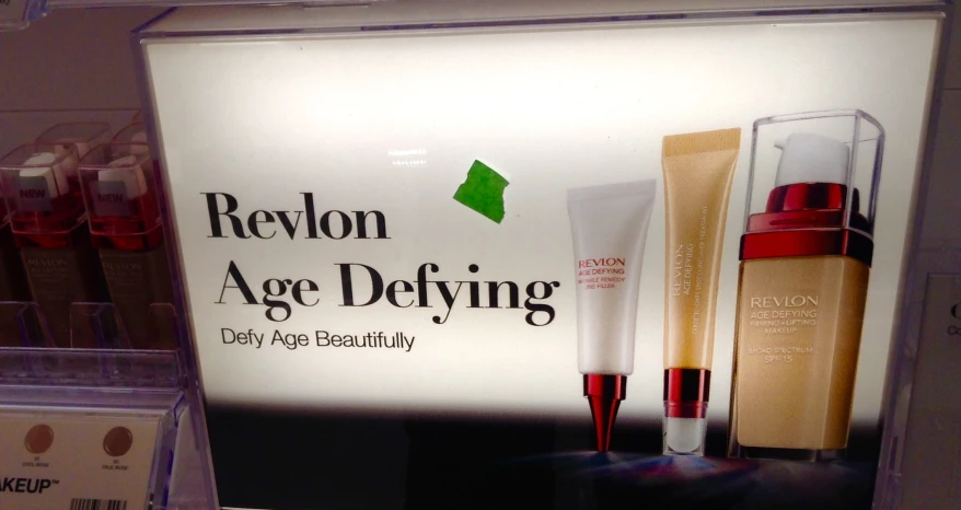 cosmetics ad displayed in a store window, with red accents