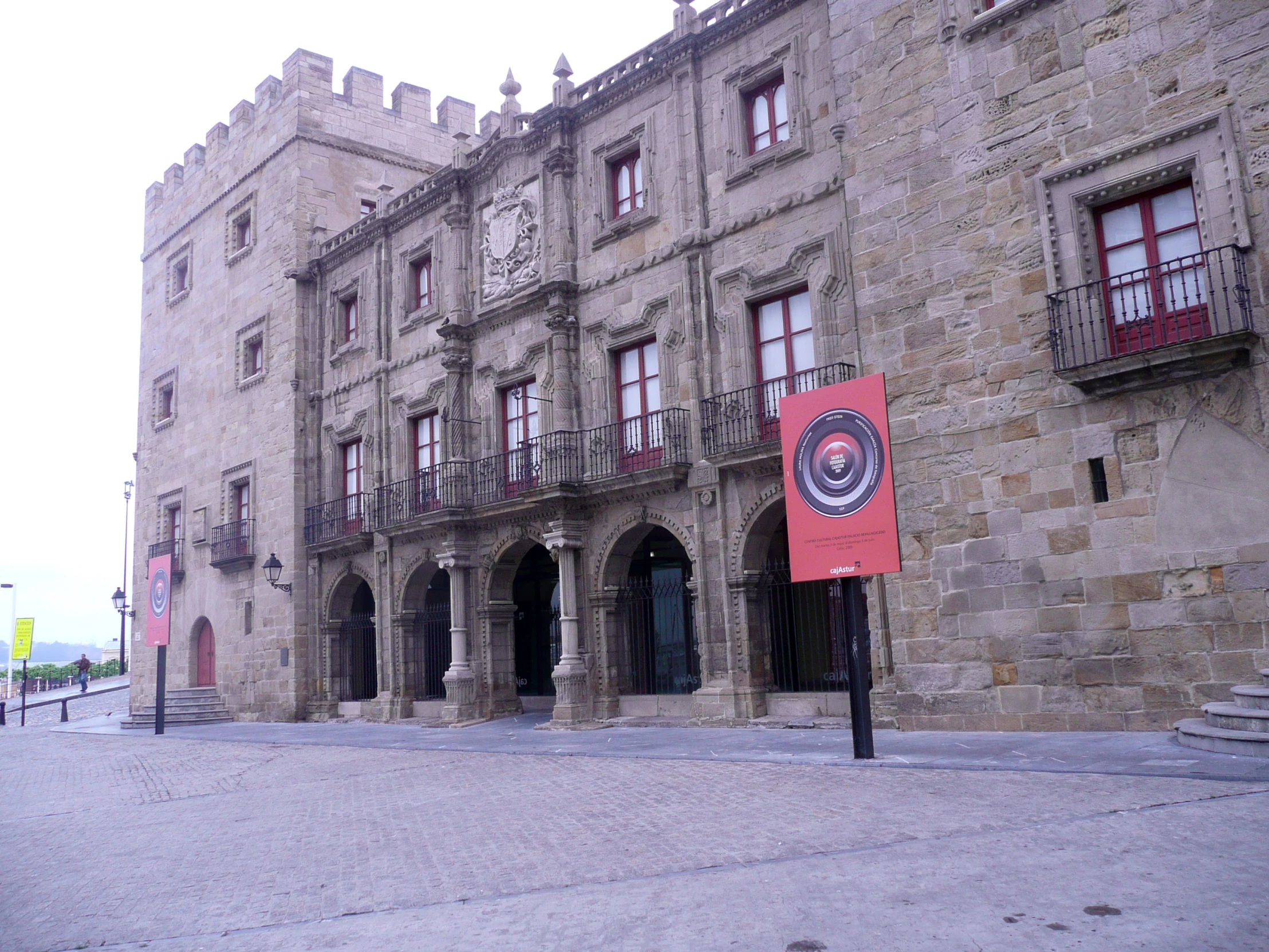 an old building that has two story, and a sign reading welcome to the city