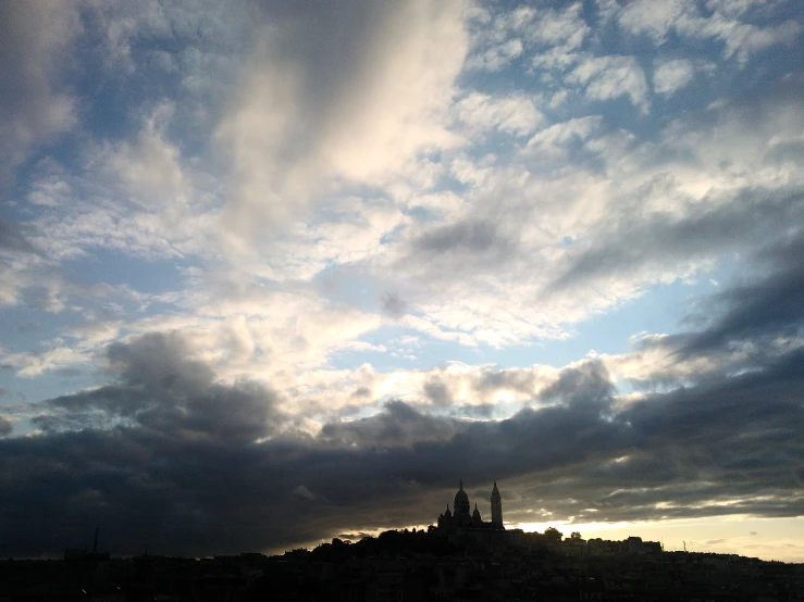 there is a small building in the middle of this cloudscape