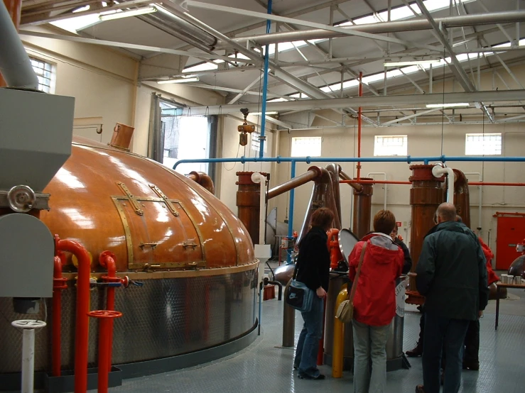 people looking at large objects in an industrial building