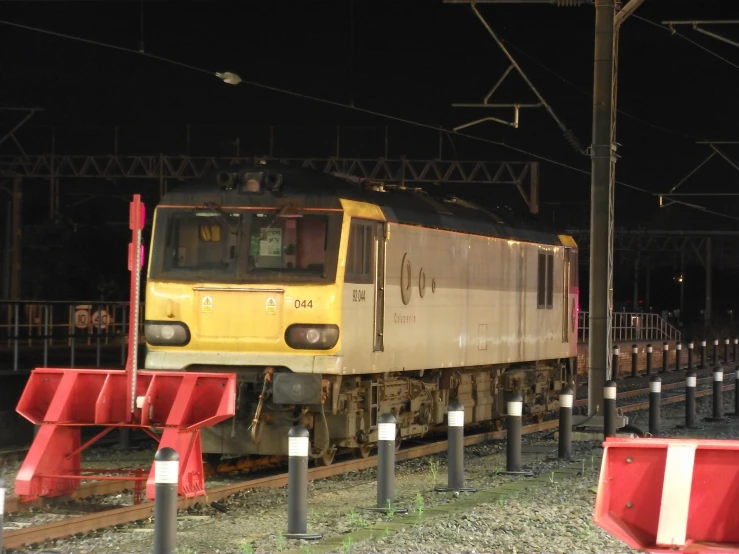 a train traveling on the tracks at night