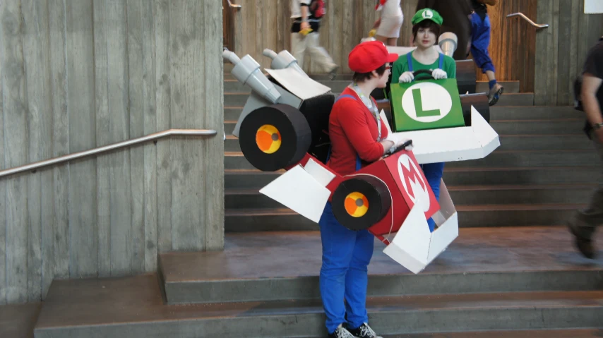 a young man is walking in front of stairs holding paper art