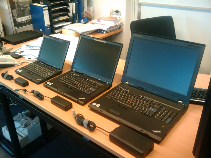 three laptops are shown in front of each other