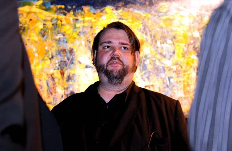 man with beard and black shirt looking up to camera