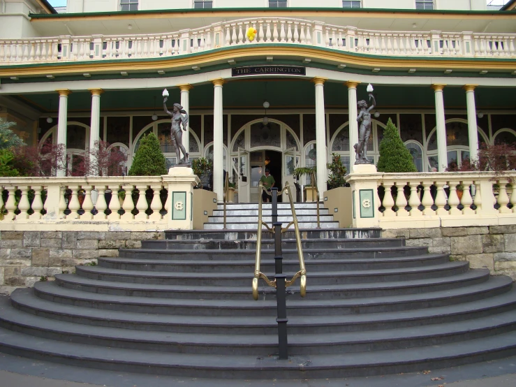 an old mansion with lots of steps leading up to the entrance