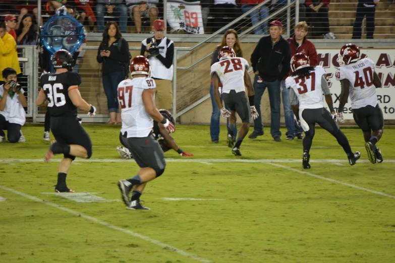 football players running on the field during a game