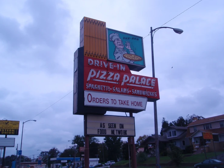 two business signs in front of some houses