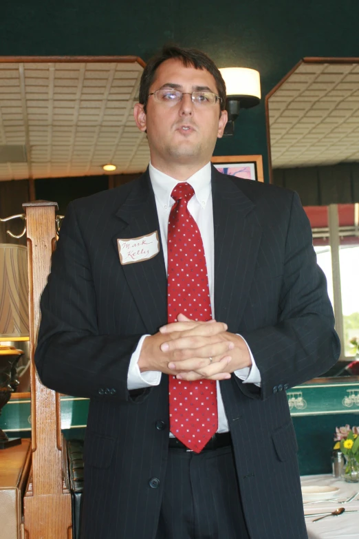 a person wearing glasses and a suit and tie