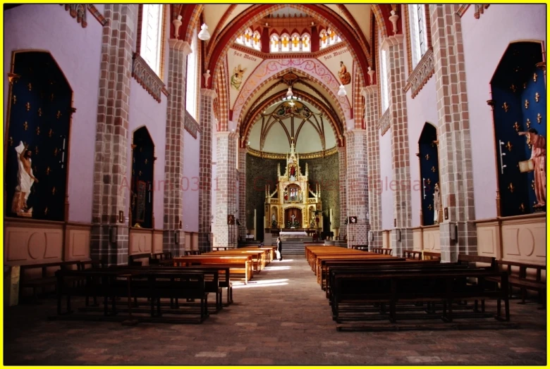 inside of a building with benches, stained glass windows and arches