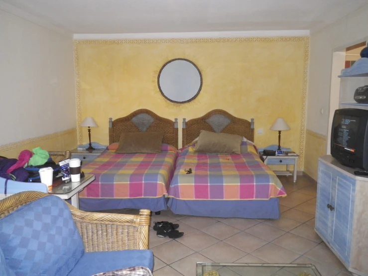 a el room with two beds and two televisions